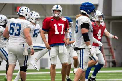 Philip Rivers pulls cleats from a trophy case to use with the Indianapolis Colts