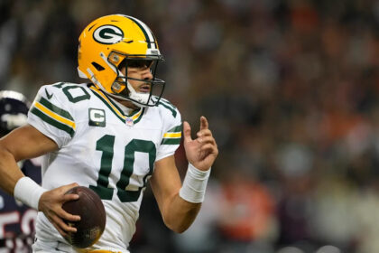 Jordan Love leaves game for training room after taking an illegal hit