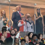 Who is sitting with Donald Trump at Indiana-Miami national championship game?