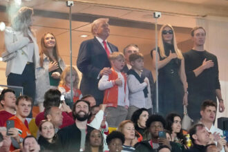 Who is sitting with Donald Trump at Indiana-Miami national championship game?