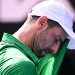 Djokovic scrapes into semis after Musetti injury