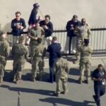 US men's hockey stars share gold medal moment with military members before White House visit