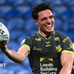 Leeds run riot at Huddersfield to go top