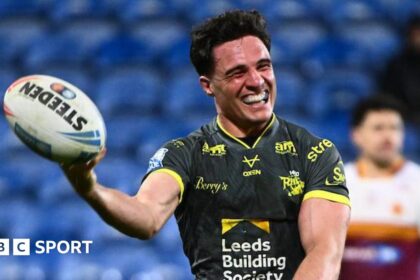 Leeds run riot at Huddersfield to go top