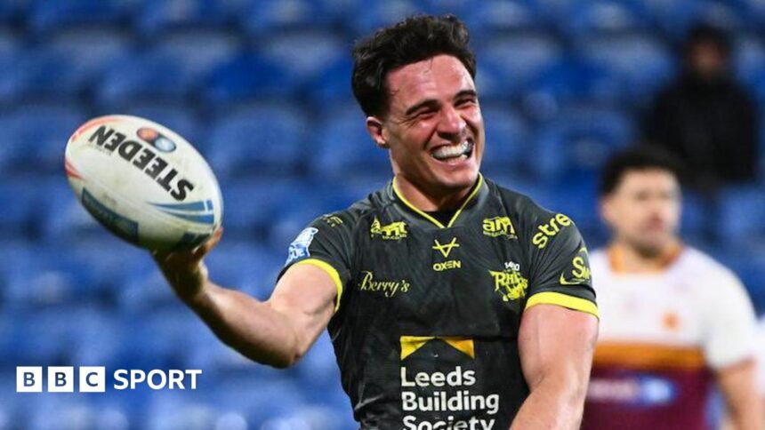 Leeds run riot at Huddersfield to go top